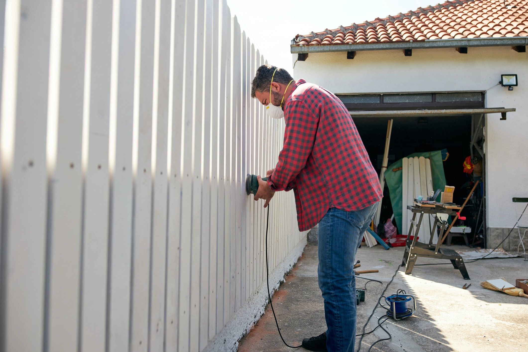 Contractor finishing a wood fence