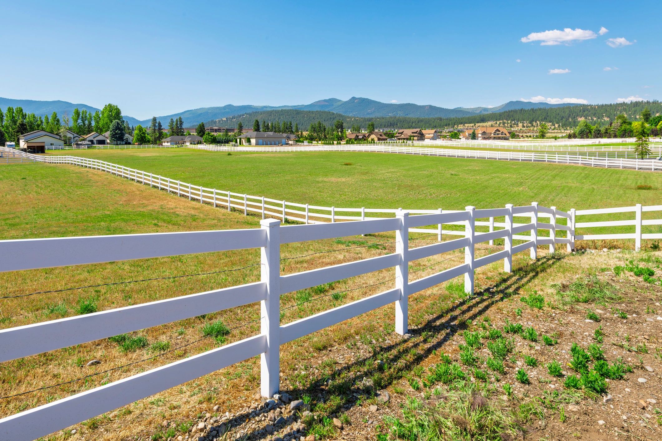 Long post and rail fence run with open views