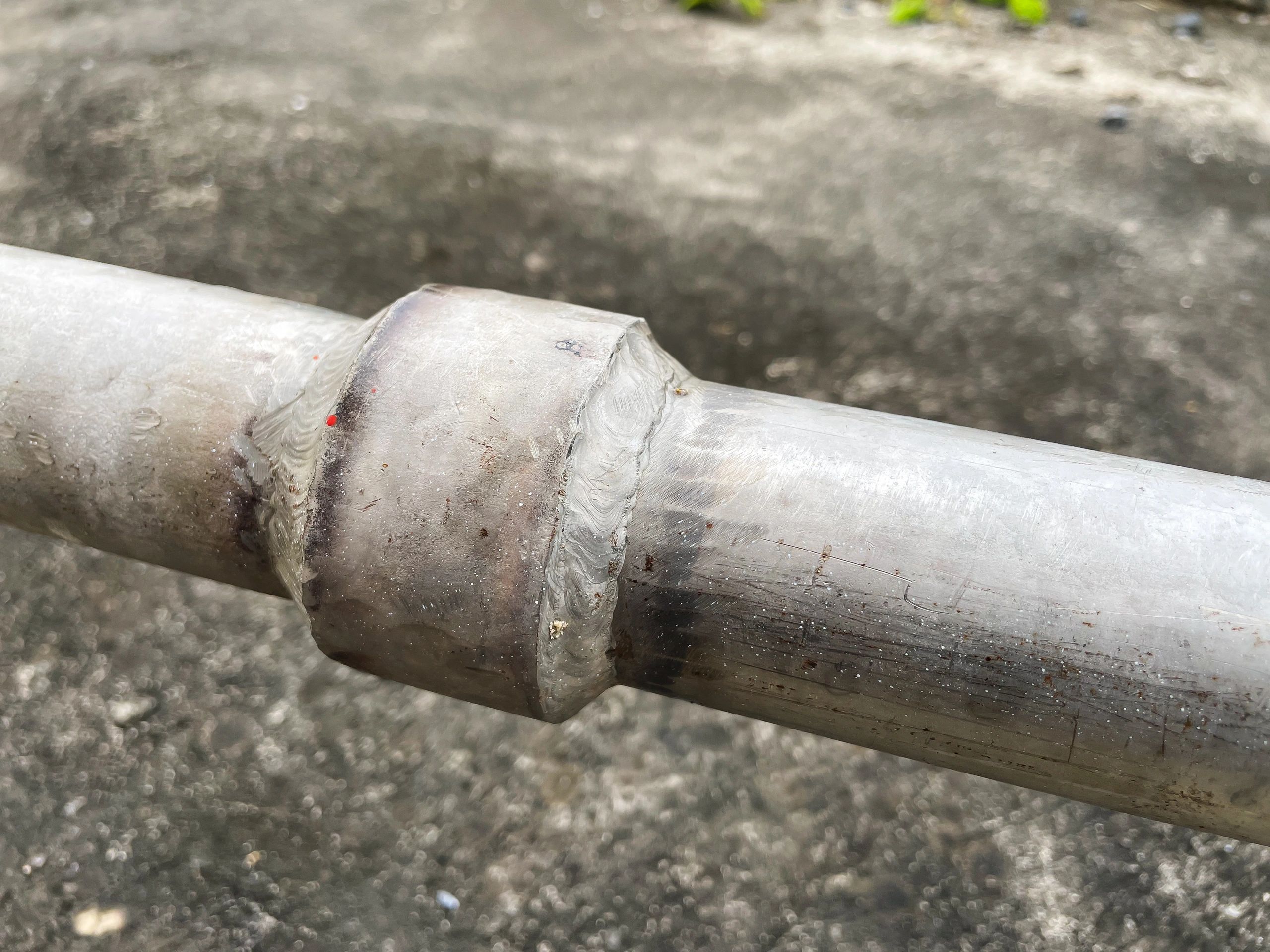 Close-up of metal pipe joint representing chain link framework sizing